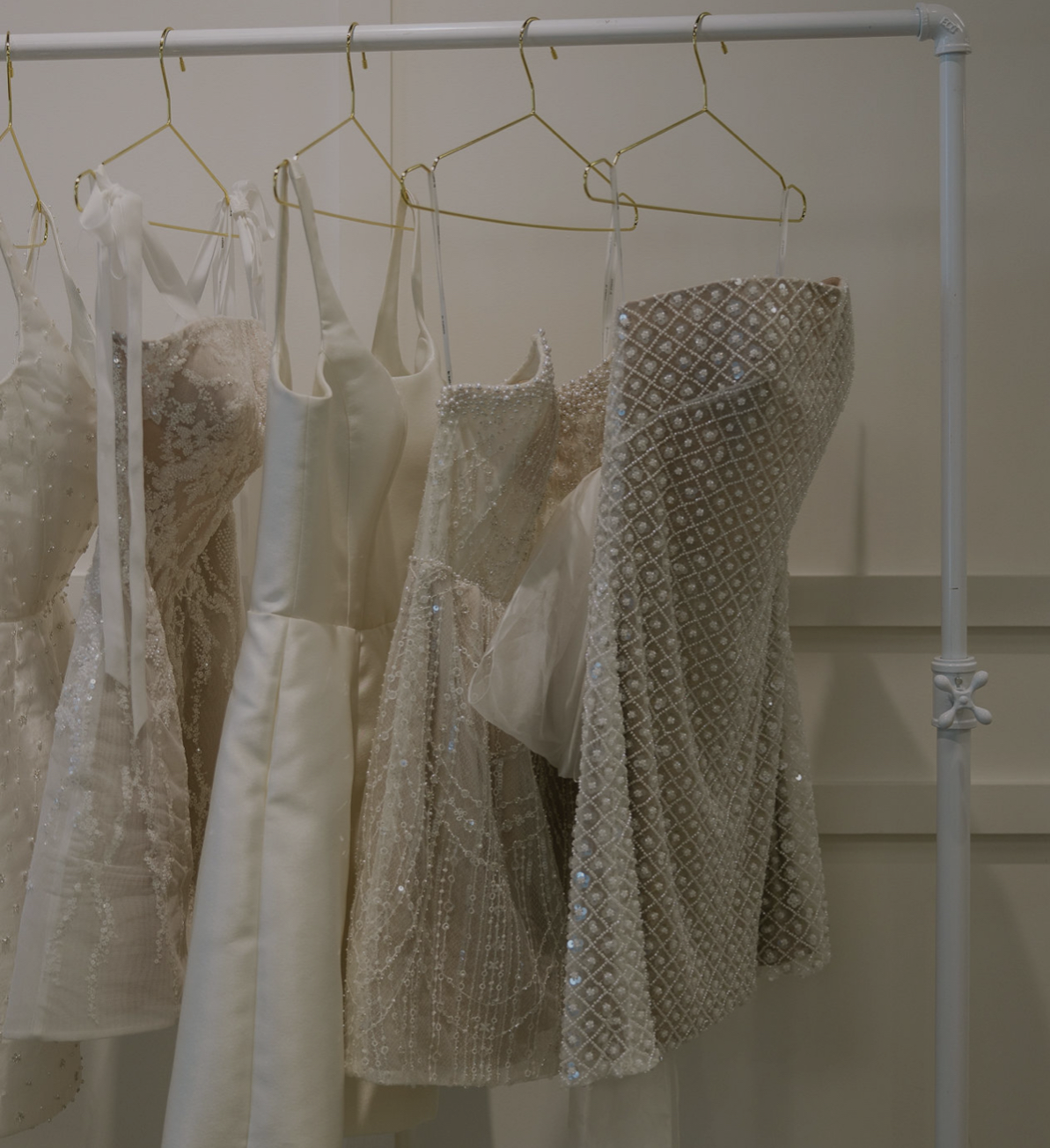 Model wearing a white dress. Mobile image