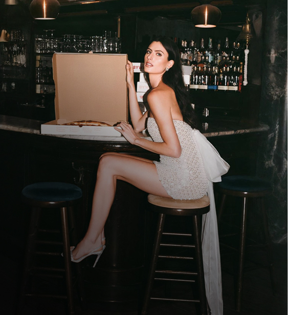 Model wearing a white dress. Mobile image