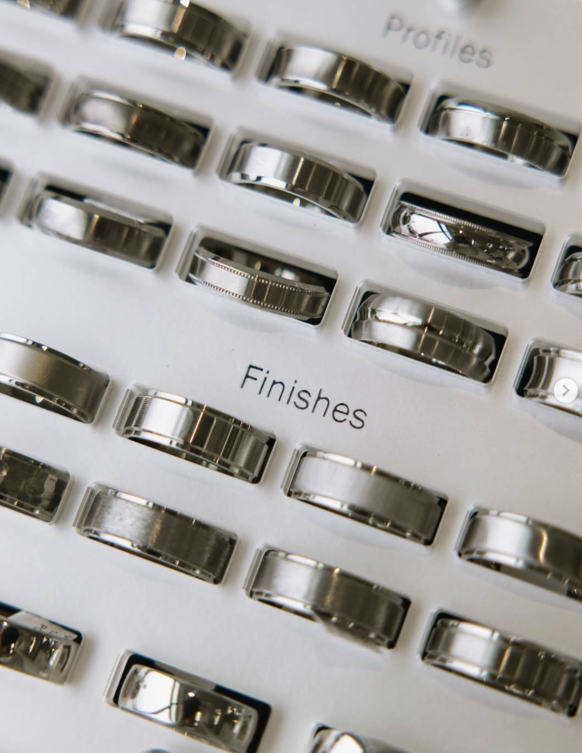 A collection of metallic rings displayed in rows, labeled 