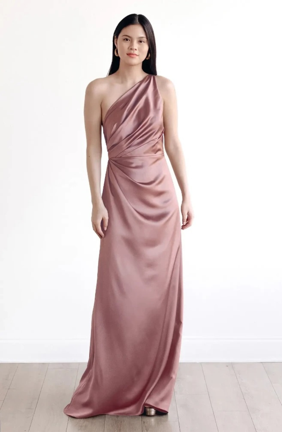 model is wearing a one shoulder evening dress